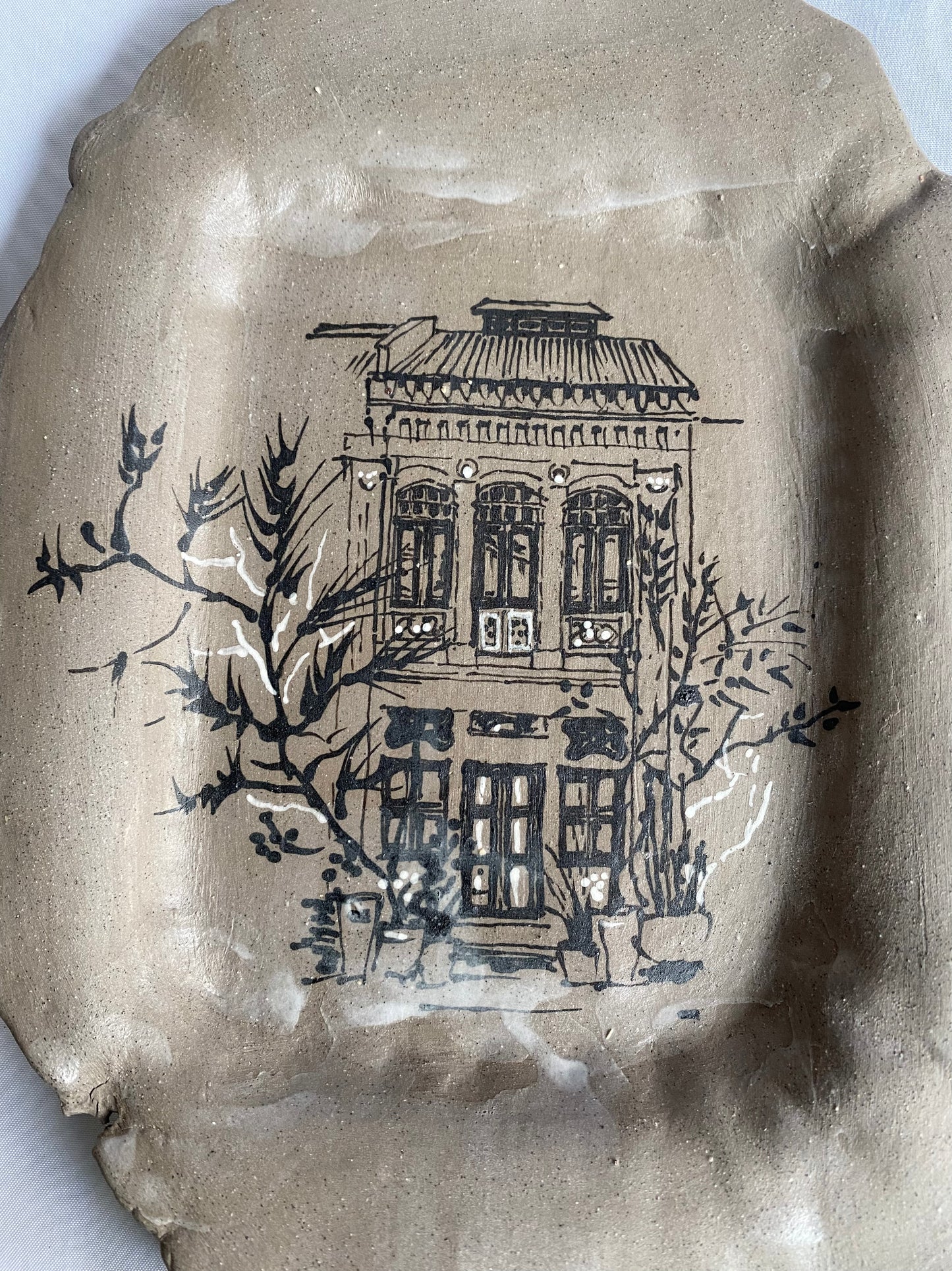 Hand-painted ceramic plate featuring Singapore shophouse architecture, artisan heritage flatware by foRM of Mondays.
