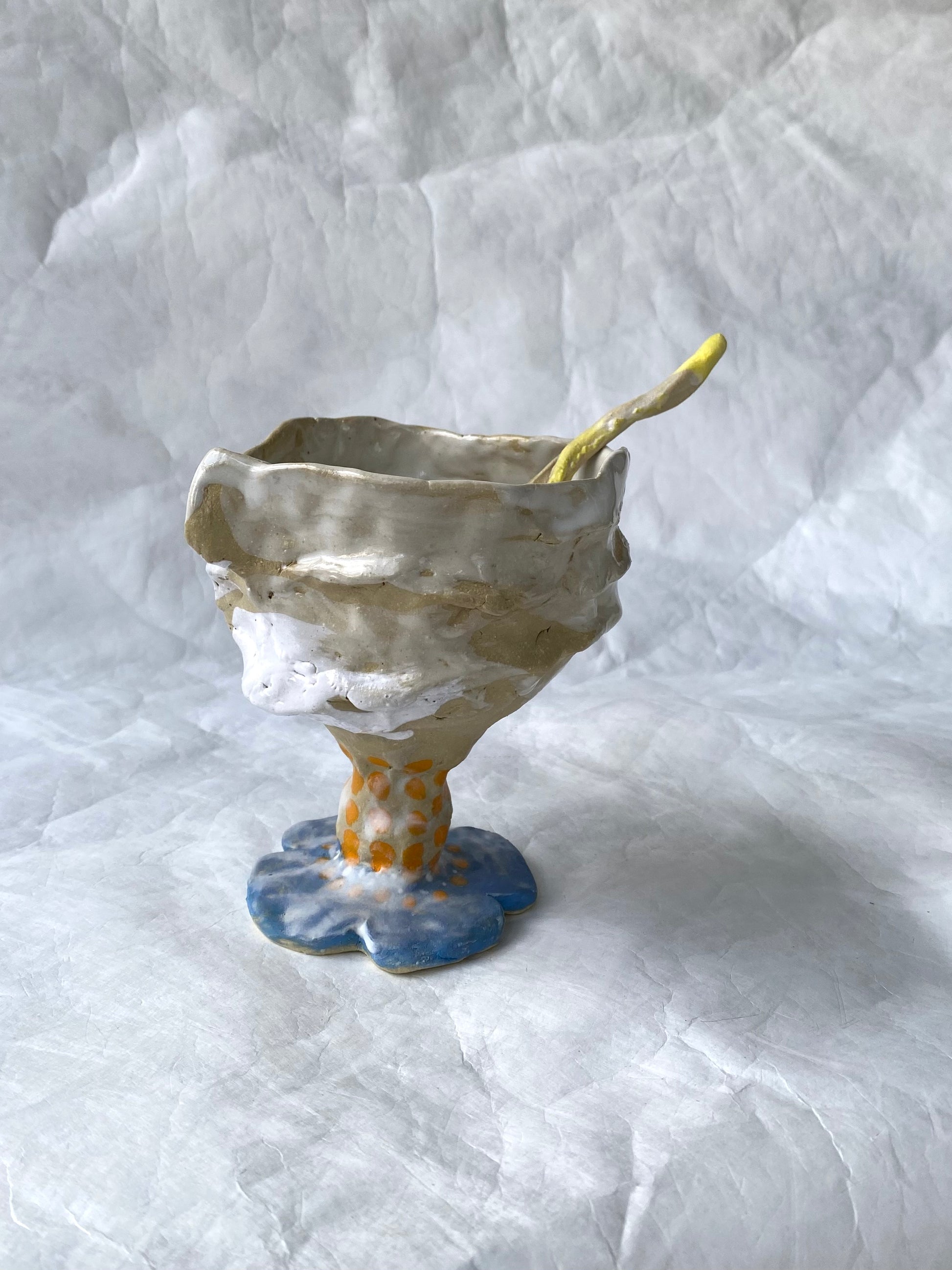 A hand-built set of ceramic sundae cup and spoon,  inspired by nature’s imperfections, by foRM of Mondays Singapore.