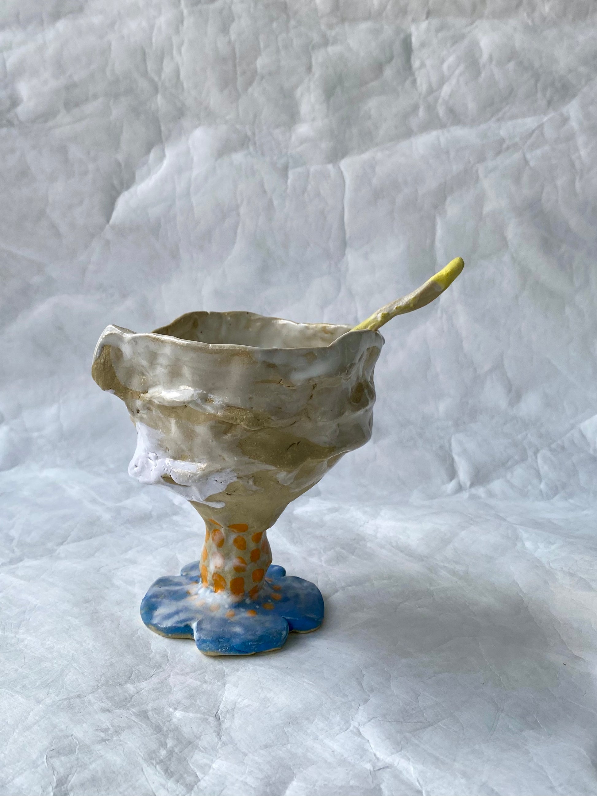 A hand-built set of ceramic sundae cup and spoon,  inspired by nature’s imperfections, by foRM of Mondays Singapore.