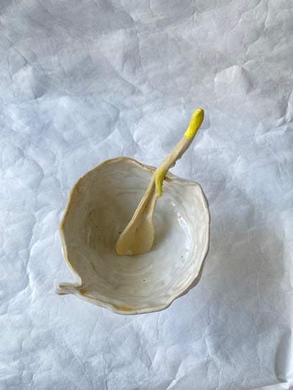 Whimsical ceramic bowl with a yellow spoon by foRM of Mondays 