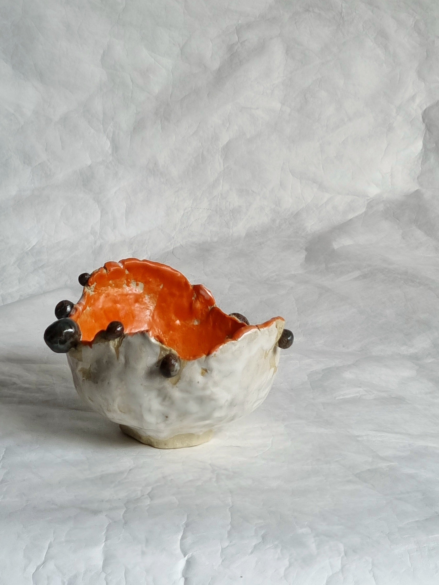 A whimsical ceramic bowl in a white background 