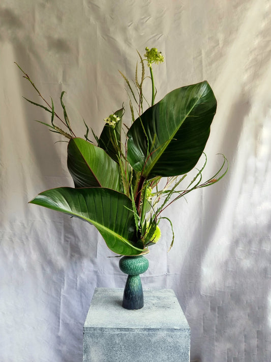 A green floral sculpture in a vase, designed as a sweet, artistic gesture for the home.
 