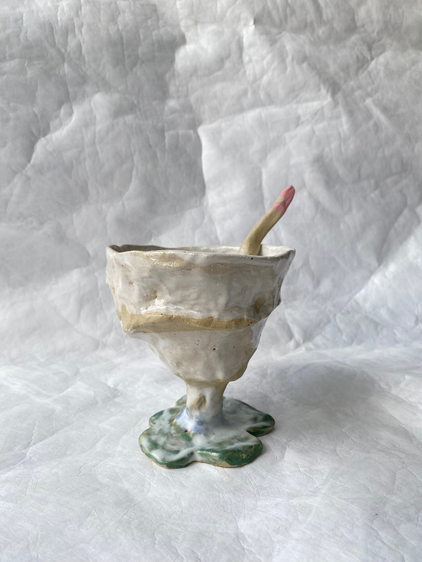 A hand-built set of ceramic sundae cup and spoon,  inspired by nature’s imperfections, by foRM of Mondays Singapore.