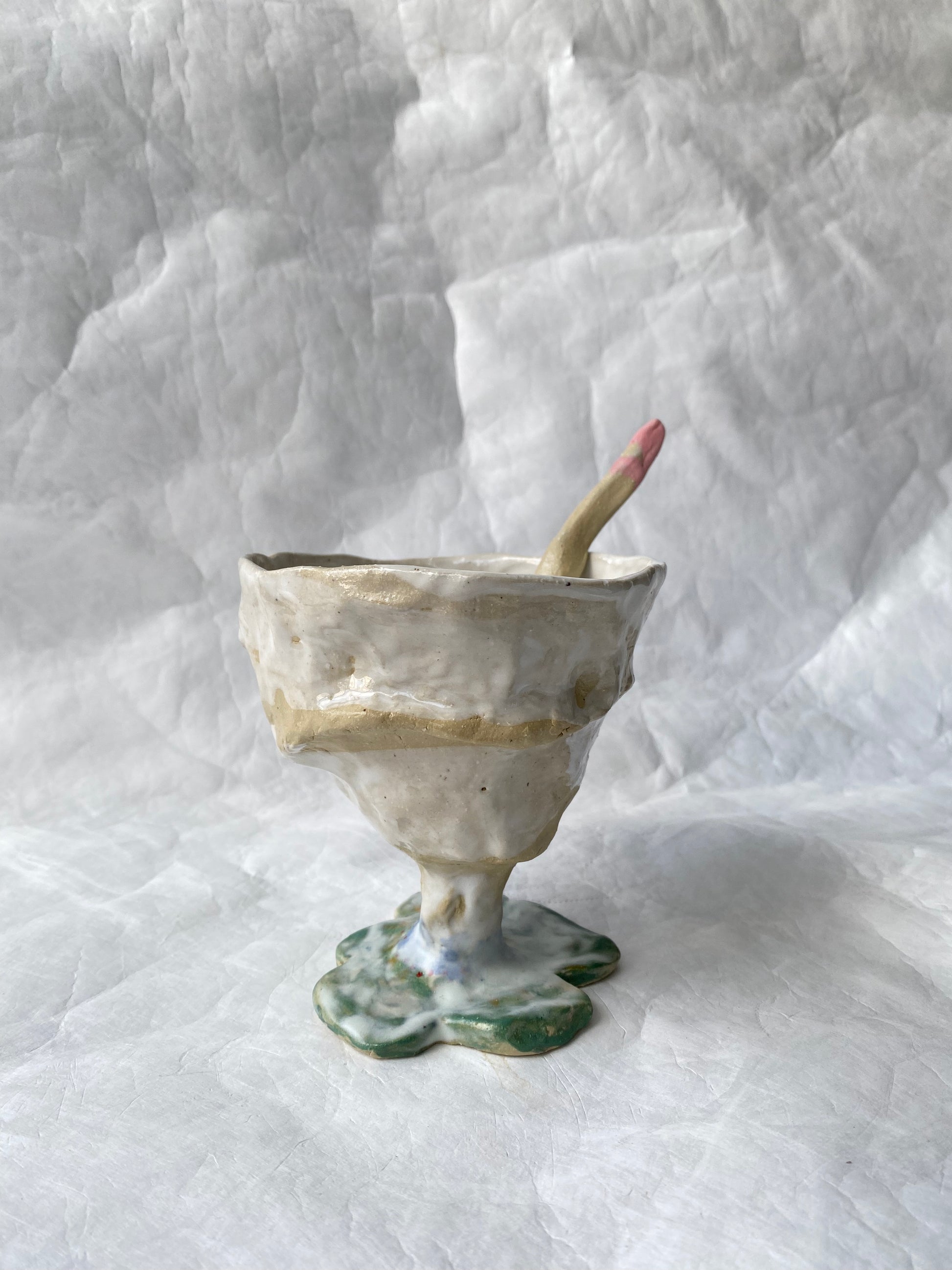 A hand-built set of ceramic sundae cup and spoon,  inspired by nature’s imperfections, by foRM of Mondays Singapore.