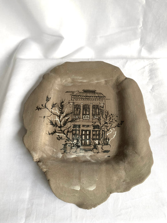 Hand-painted ceramic plate featuring Singapore shophouse architecture, artisan heritage flatware by foRM of Mondays.
