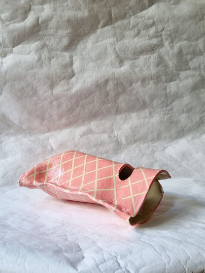 A hand-built stoneware ceramic vessel resembling a pink shopping bag, a sculptural art piece exploring modern consumption by foRM of Mondays.