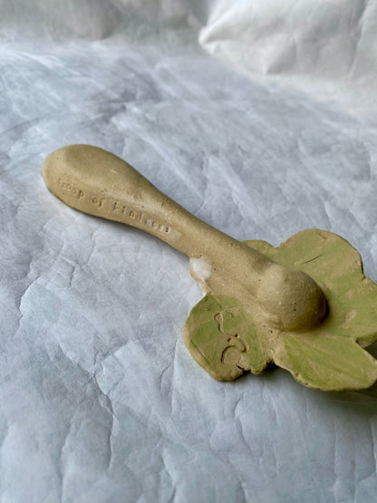 Green ceramic spoon with floral design and scoop of kindness imprinted 