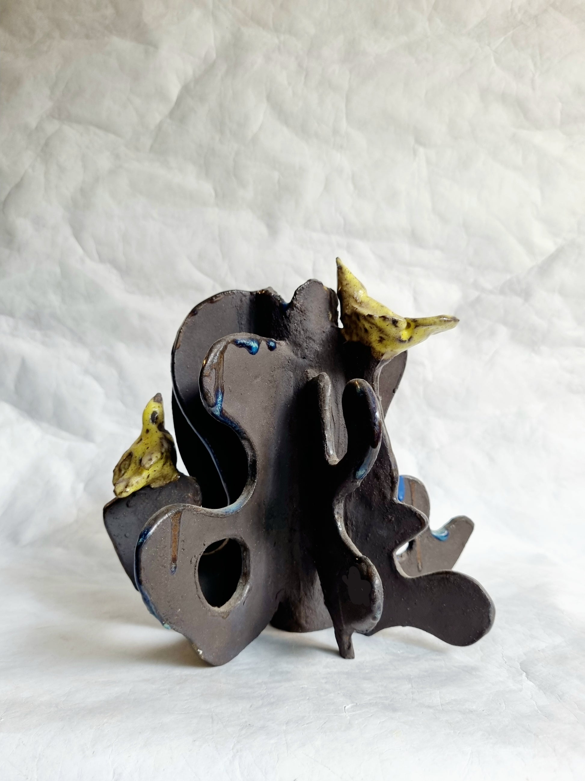 A limited-series ceramic vessel from the Sunbirds Collection by foRM of Mondays, featuring organic, highly textured black  clay work with abstract references to a kinetic energy 
